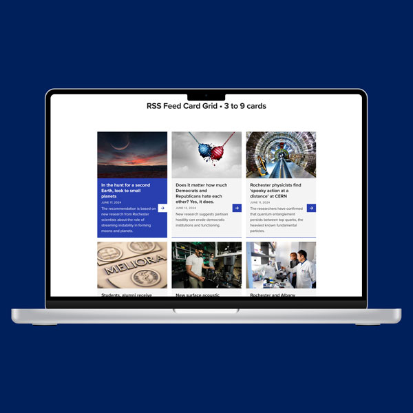 Open laptop displaying a webpage with a 3x2 RSS feed card grid layout.